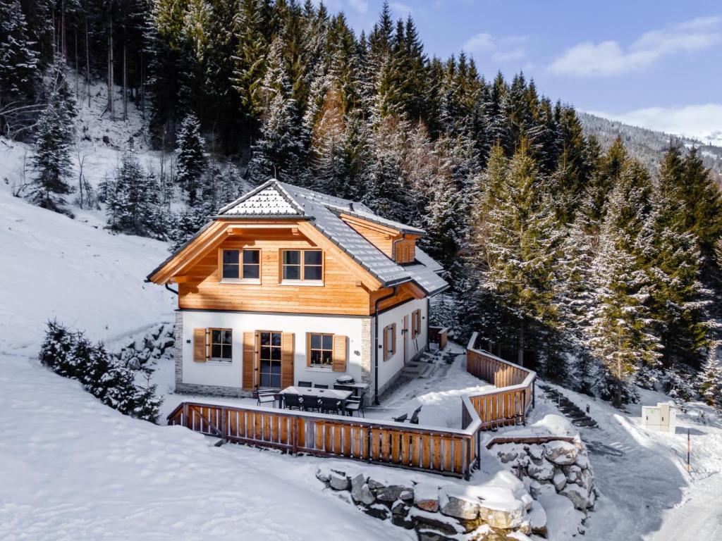 a wooden house in the snow in the mountains at Schletski in Donnersbachwald