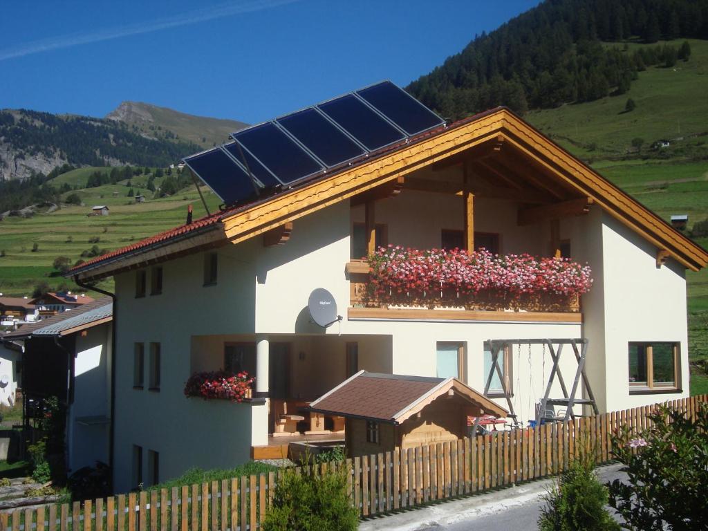 a house with a solar roof with flowers on it at Ferienwohnung Abraham in Nauders