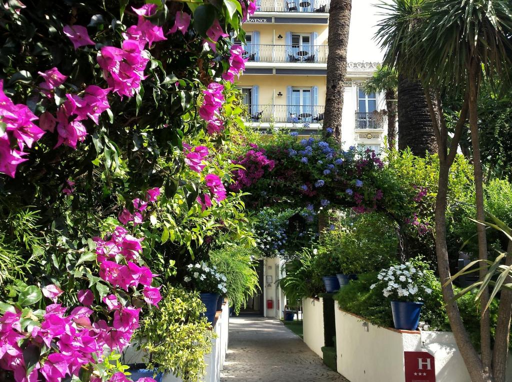 a garden of flowers and plants in front of a building at Hôtel de Provence in Cannes