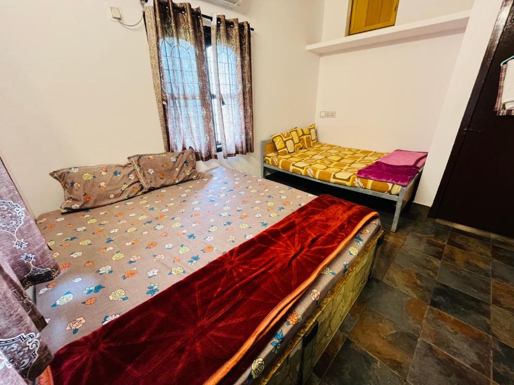 a bedroom with two beds in a room at Coastal Nest Home - Malpe Beach in Malpe