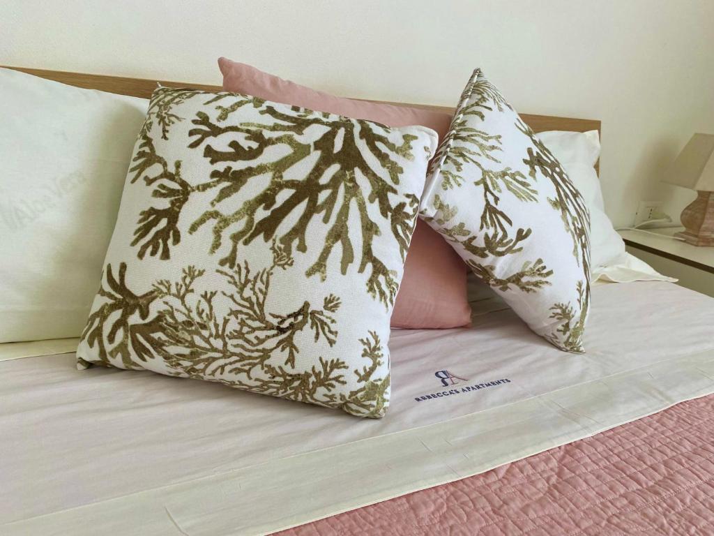 two pillows sitting on top of a bed at ARTs at Portovenere in Portovenere
