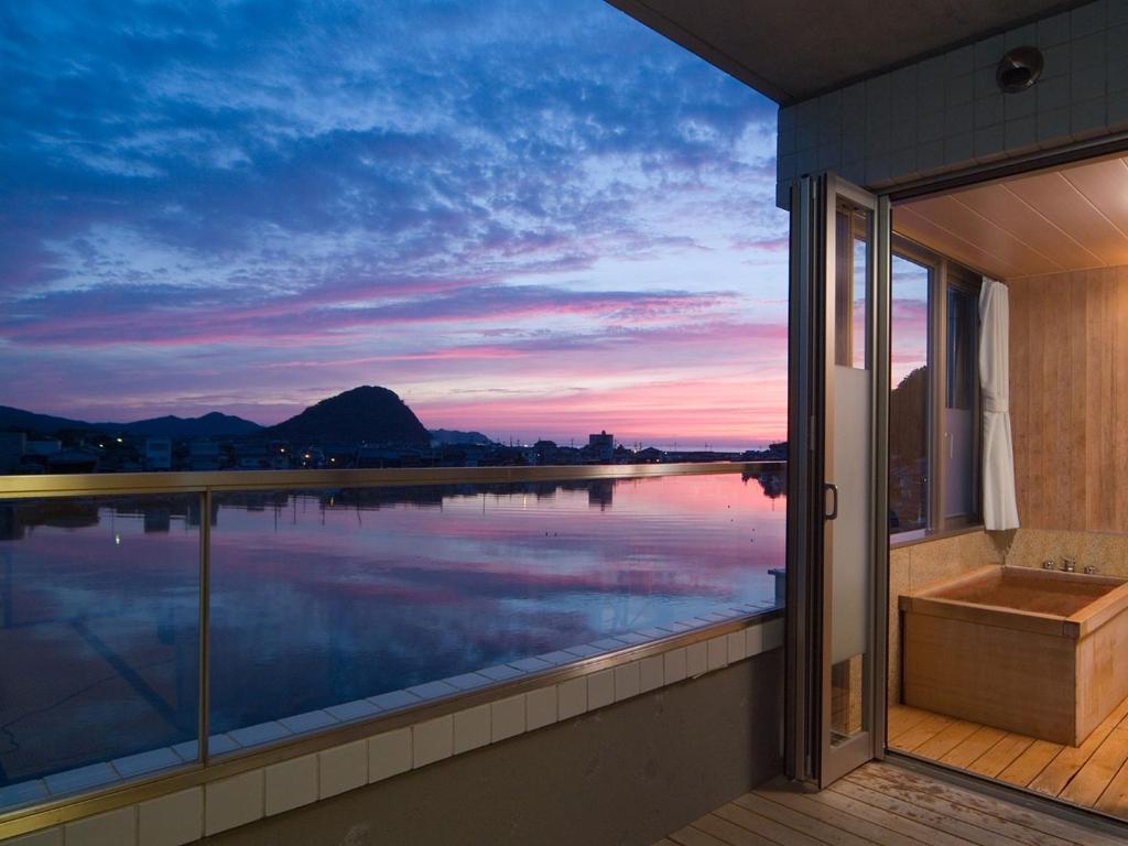 a balcony with a view of a body of water at 萩八景 雁嶋別荘 in Hagi
