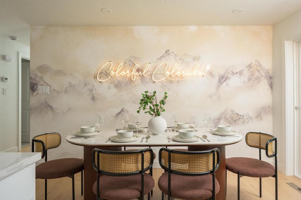 a dining room table with chairs and a sign that reads vacation chicago at Sleeps 16 Hot Tub Arcade Movie Theater Pool Table in Westminster