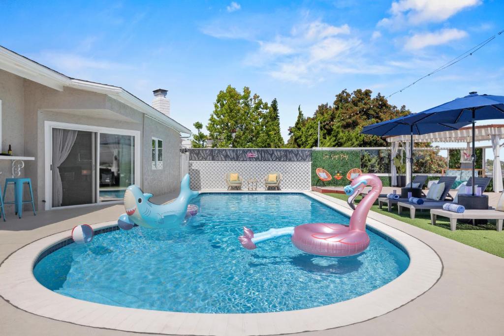 a swimming pool with two inflatable animals in the water at Relax and Play-Pool, Spa, Views plus Guest House! in La Mesa