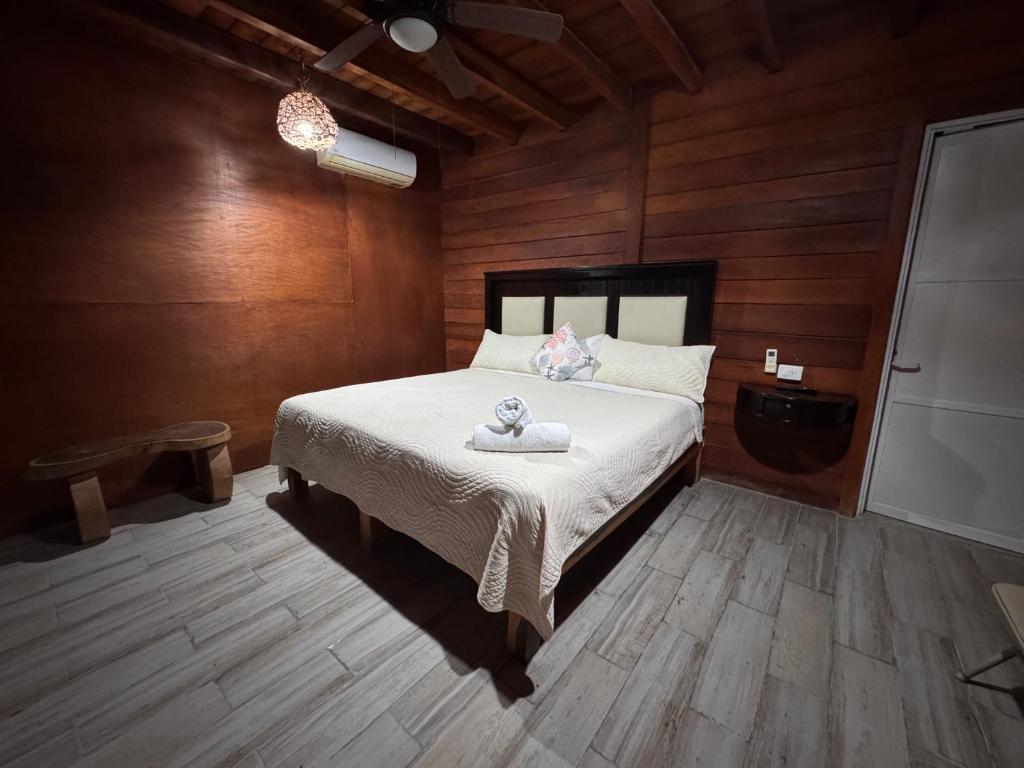 a bedroom with a bed with a teddy bear on it at Hotelito Villas Holbox in Holbox Island