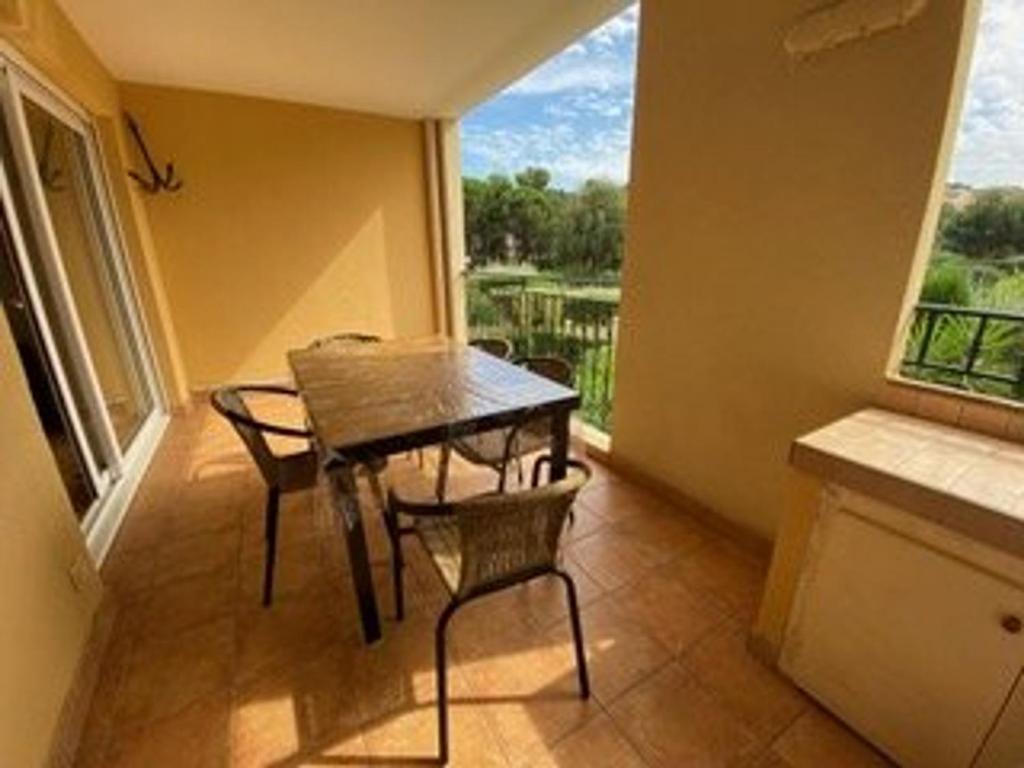 a dining room with a table and chairs and a window at Appartement 3 pièces avec climatisation dans résidence avec piscines et tennis - FR-1-100-364 in Cavalaire-sur-Mer