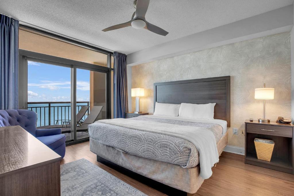 a hotel room with a bed and a balcony at Anderson Ocean Club #1611 in Myrtle Beach