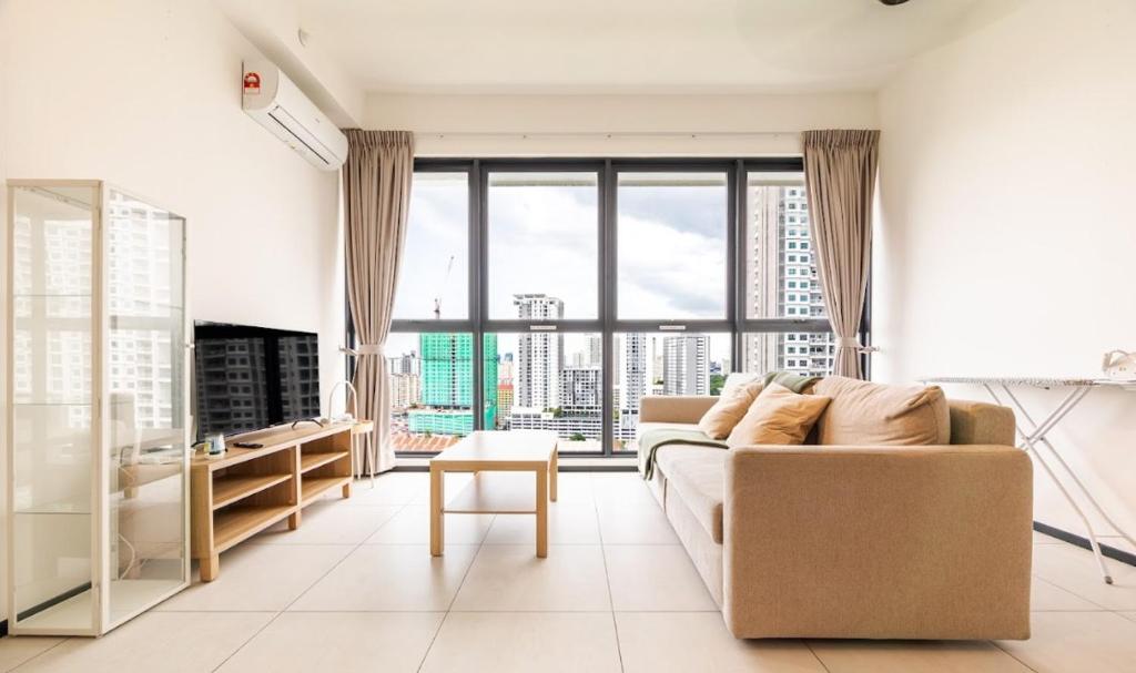 a living room with a couch and a large window at Urban Suites, Georgetown Penang - Near USM, Lam Wah EE in George Town