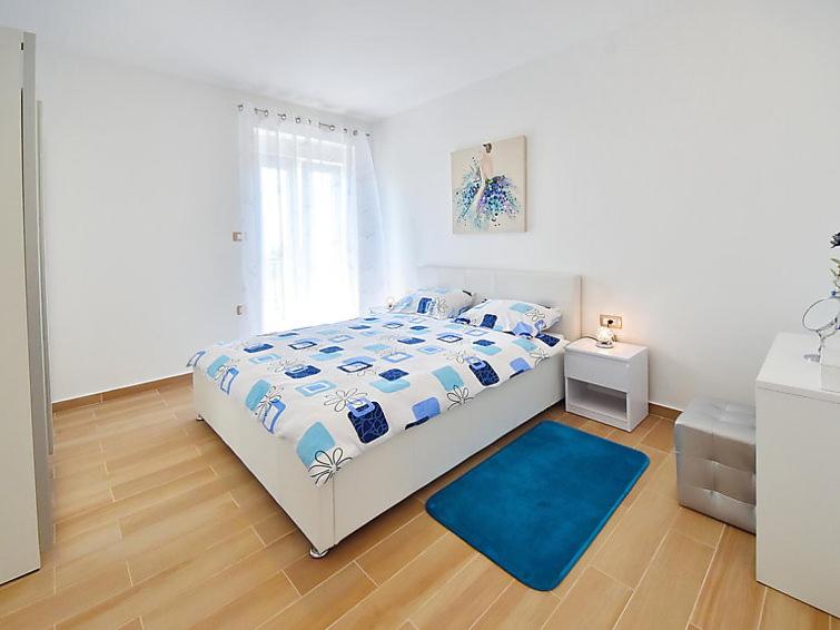 Łóżko lub łóżka w pokoju w obiekcie Apartments Garden Residence Opatija