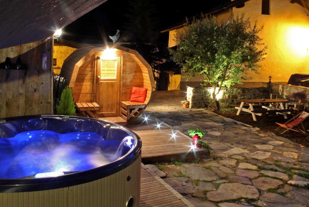 a jacuzzi tub in a backyard at night at Chalet Eterlou in Tignes