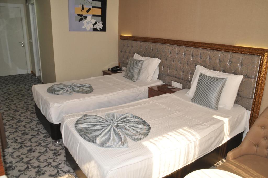 Postel nebo postele na pokoji v ubytování Grand Sera Hotel