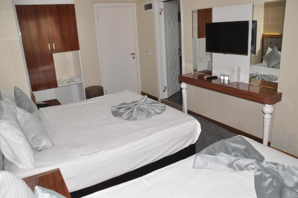 Postel nebo postele na pokoji v ubytování Grand Sera Hotel