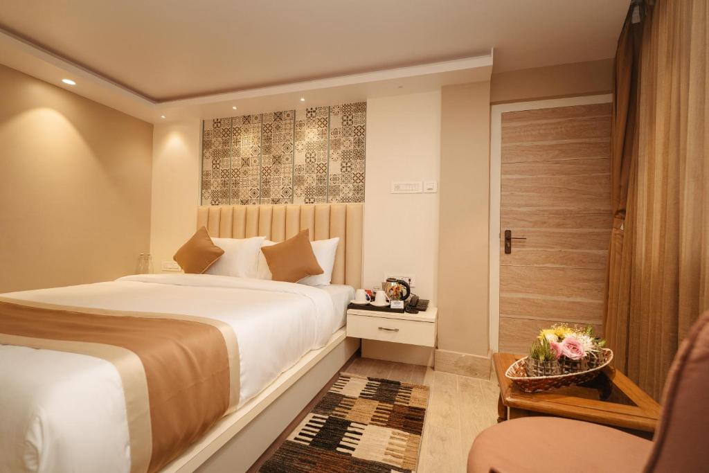 a hotel room with a bed and a door at PENANG Home Away From Home in Darjeeling