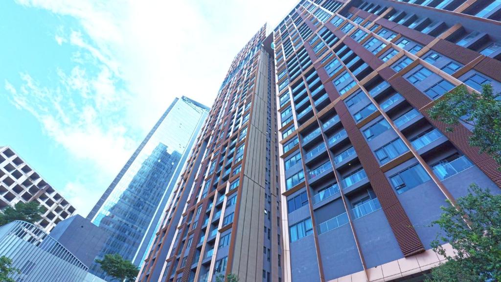 a tall building with many windows in a city at Lucentia Residence Bukit Bintang By Panorama in Bukit Bintang