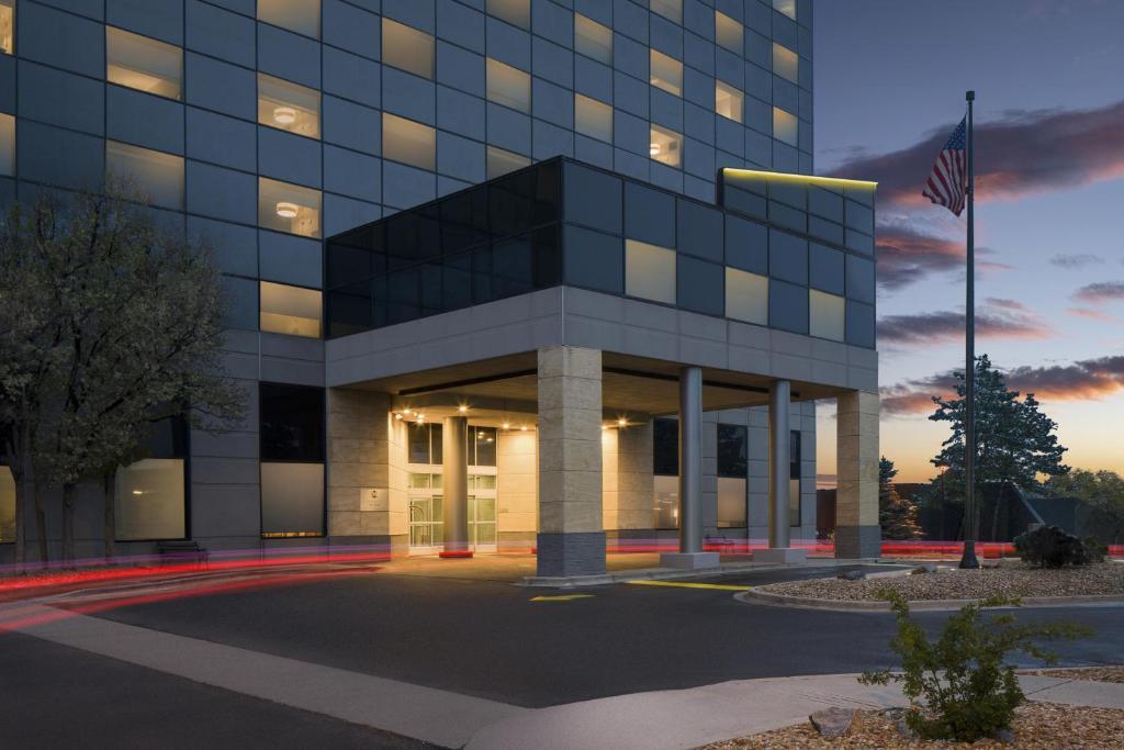 an office building with a flag in front of it at Hyatt Place Denver Cherry Creek in Denver