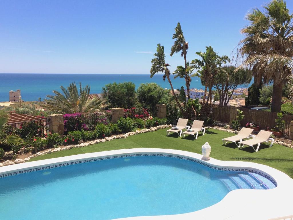 a swimming pool with a view of the ocean at Casa Olina in Bahia de Casares