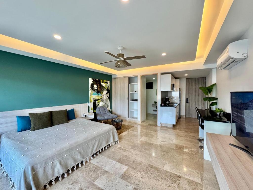 a bedroom with a bed and a living room at Luxury Apartment top location! in Playa del Carmen