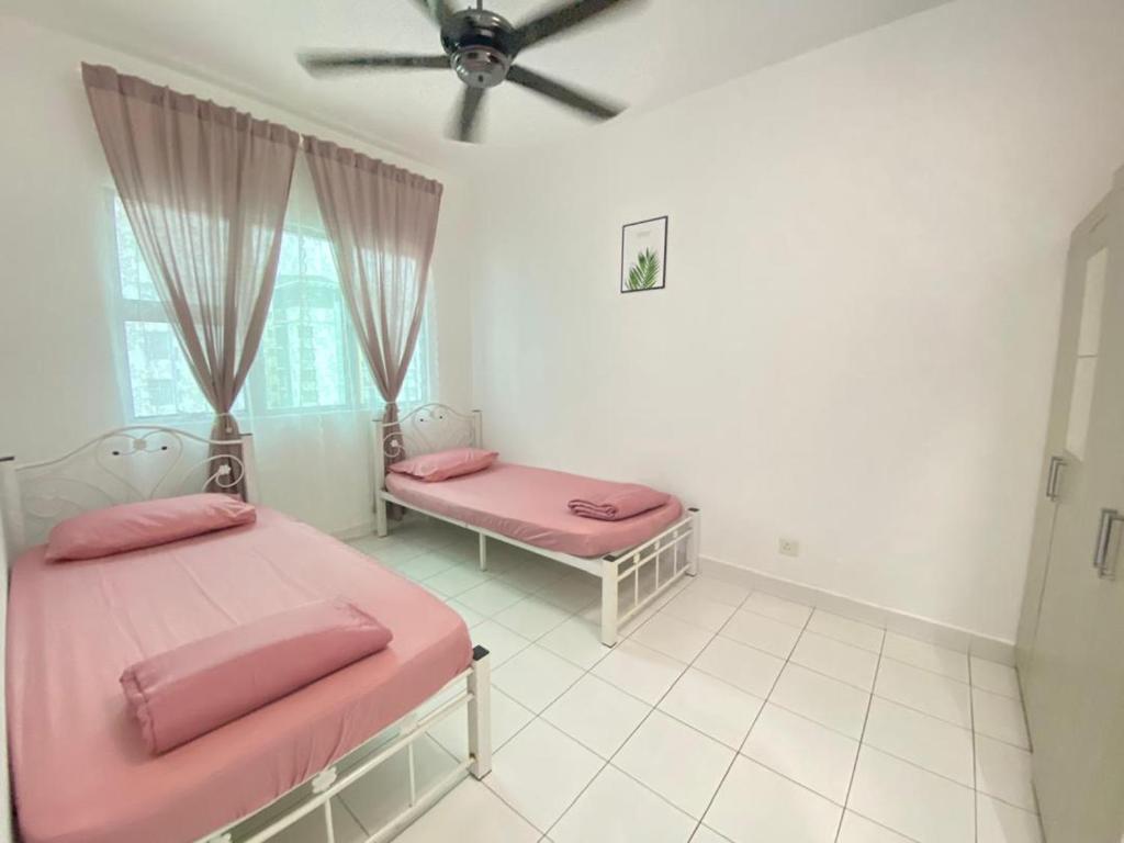 a bedroom with two beds and a ceiling fan at Homestay Putrajaya Near Lake, Dataran Putrajaya - Boulevard Putrajaya, Shaftsbury Alamanda & Masjid Putra in Putrajaya