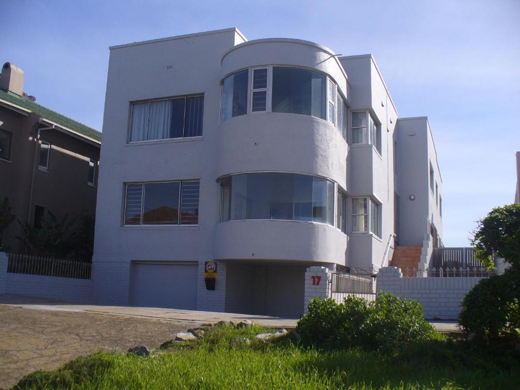 a white building with a lot of windows at Royal at Sea in Muizenberg