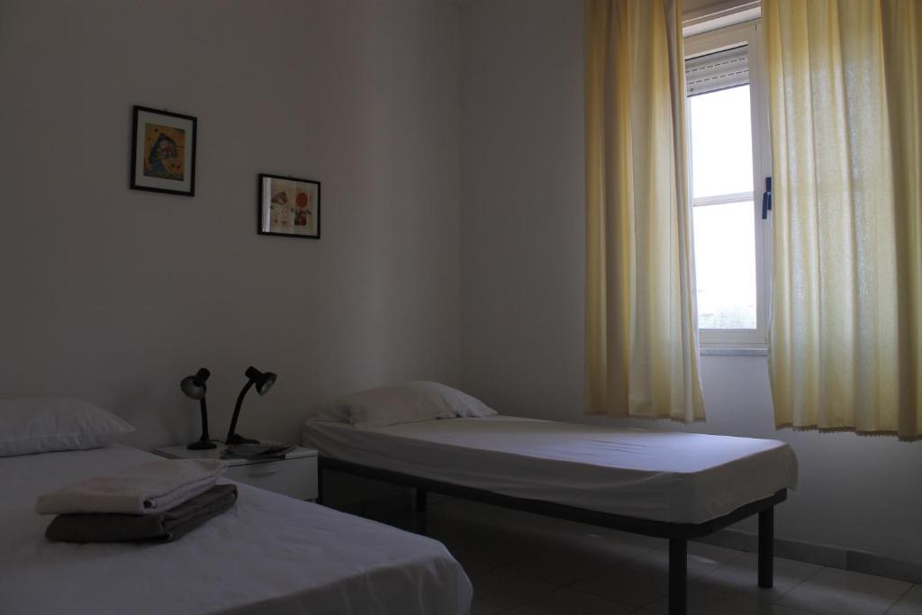 Posteľ alebo postele v izbe v ubytovaní Appartamenti Le Mimose