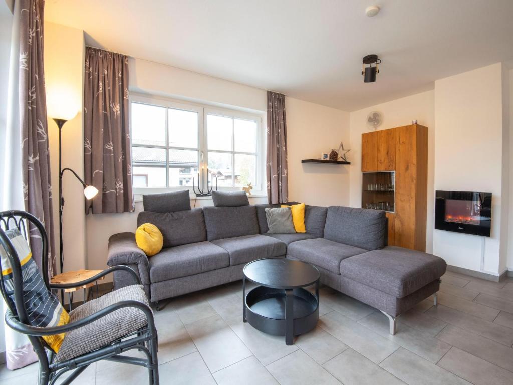 a living room with a couch and a table at Apartment near the ski slope in Brixen in Feuring