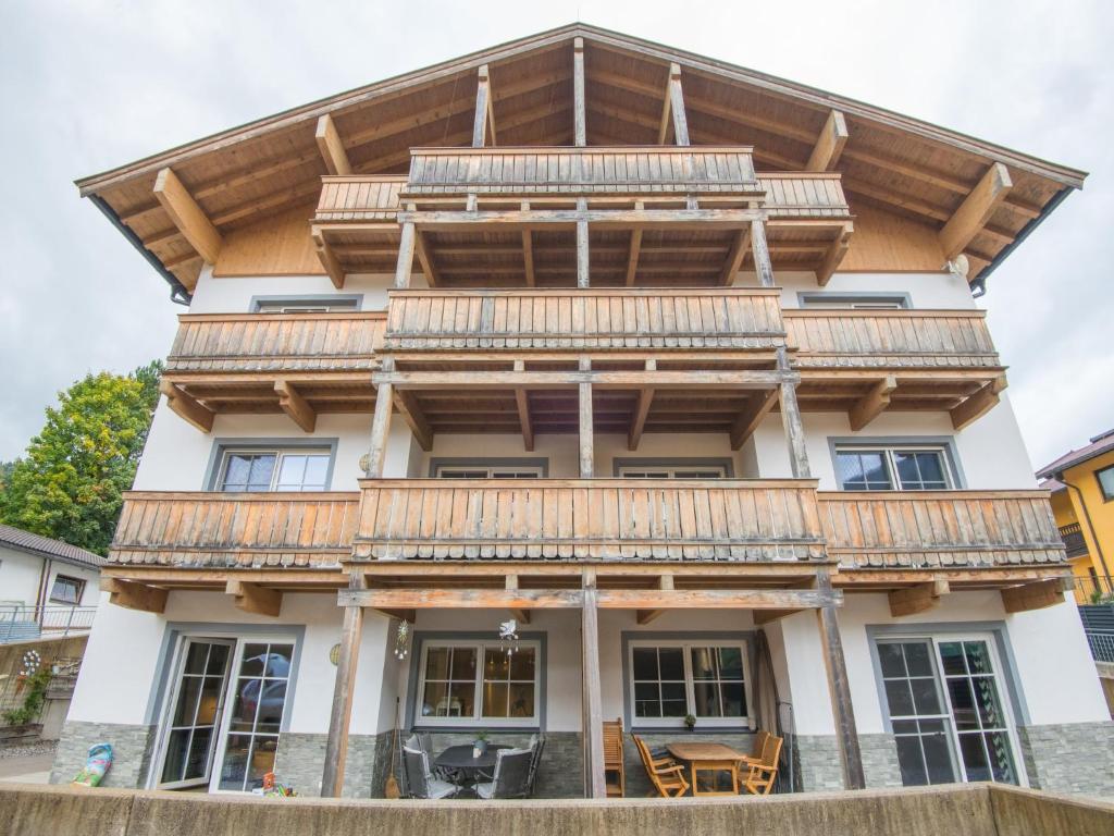 a house with wooden balconies on top of it at Modern apartment near the ski area in Brixen im Thale