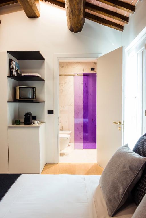 Postel nebo postele na pokoji v ubytování Hotel Milu Florence