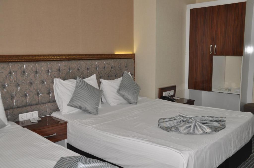 Postel nebo postele na pokoji v ubytování Grand Sera Hotel