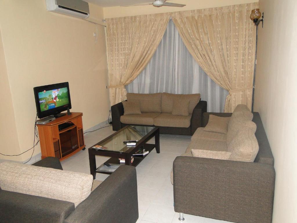 a living room with two couches and a television at BRAMA Station Court {Apartment} in Colombo