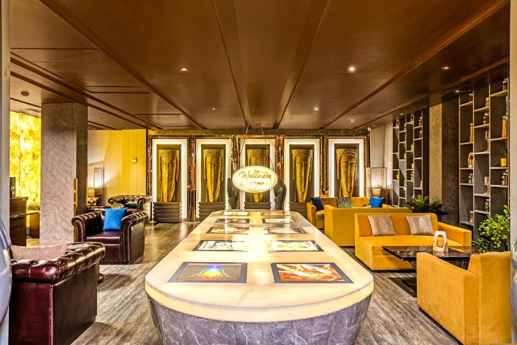 a lobby with a large table in the middle at Sterling Palm Bliss - Rishikesh in Rishīkesh