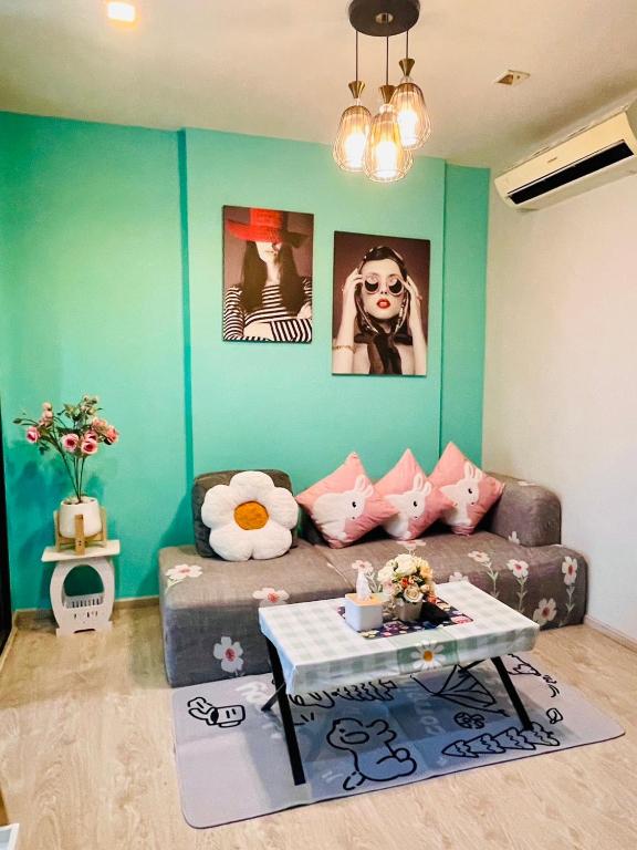 a living room with a couch and a table at The base Central 1006 by Numam in Pattaya