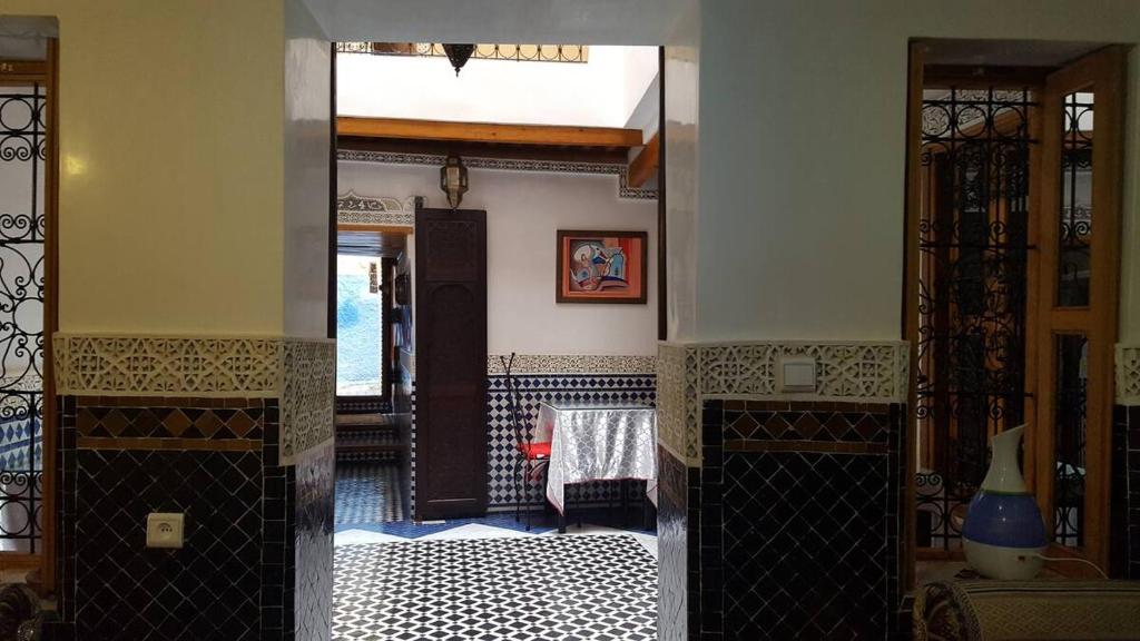 a room with a room with a bed and a doorway at Dar Nour Fes - Luxury lodging in Fès
