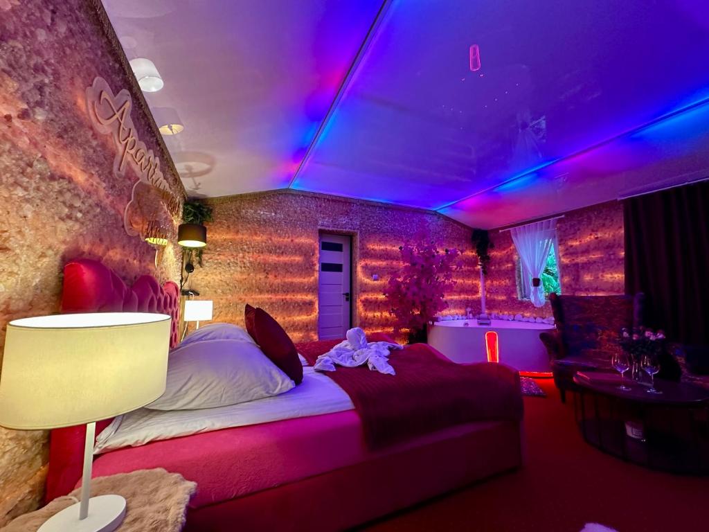 a bedroom with a bed with a purple lighting at APARTAMENT Solny SPA in Rzeszów
