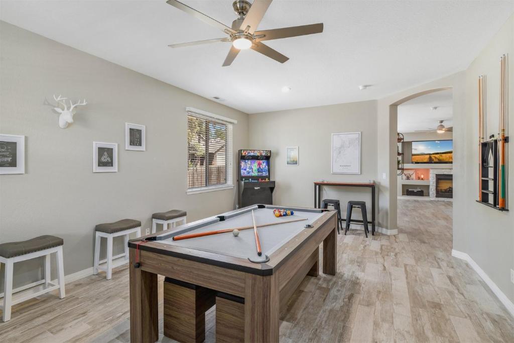 a pool table in a living room with a ceiling fan at Sublime Mountain Retreat Pool Table Fire-Pit Arcade Game Ideal Location w Central AC in Flagstaff