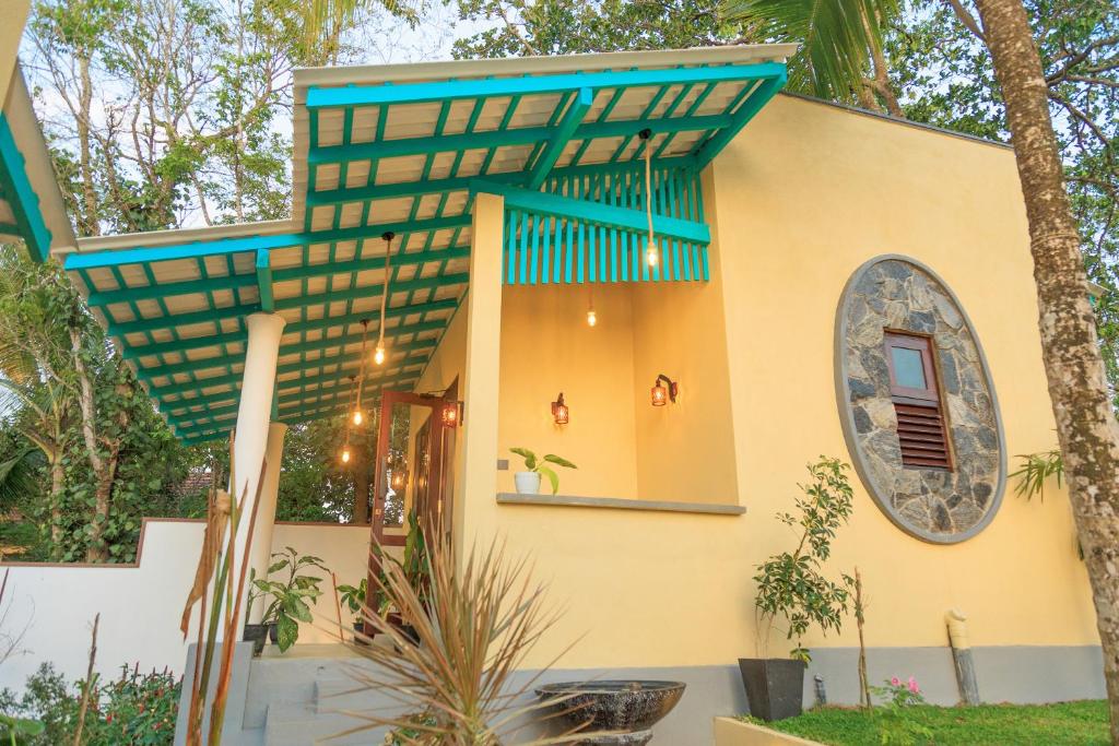 a house with a blue roof at Wind Hill Villa - Weligama in Weligama