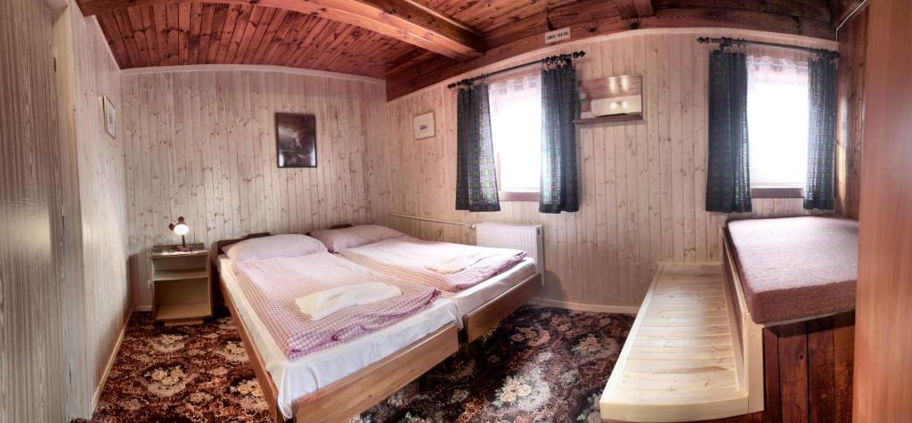 a small bedroom with a bed and a window at Pension U Stehlíků in Růžová