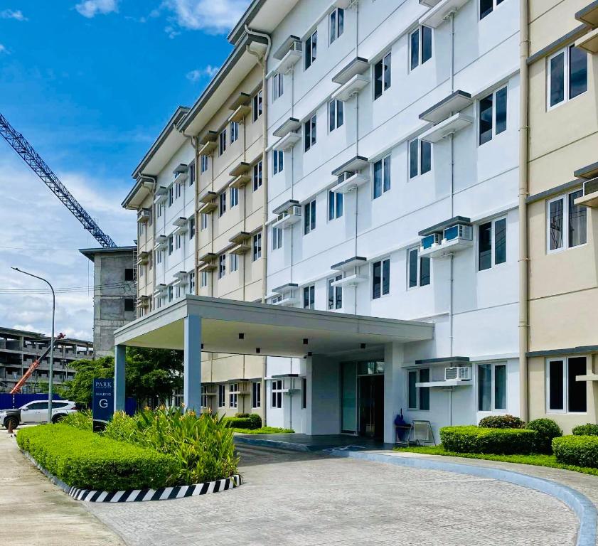 a large white building with a crane at Condo Stay Near SM City Santa Rosa Mall in Ibaba