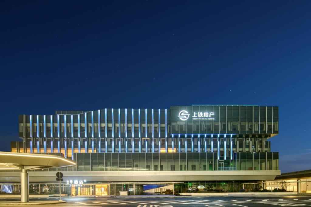 a large building with a s firm sign on it at JI Hotel Hangzhou West Railway Station in Hangzhou