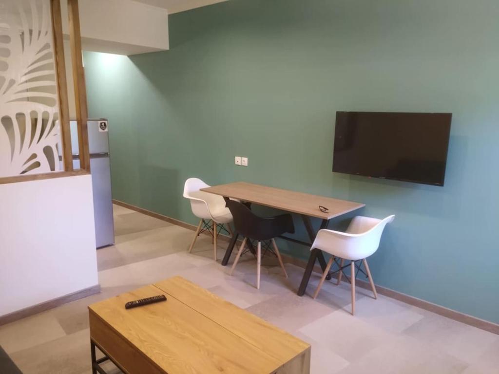 a room with a table and chairs and a tv at Stylianos House 6 in Leonidion