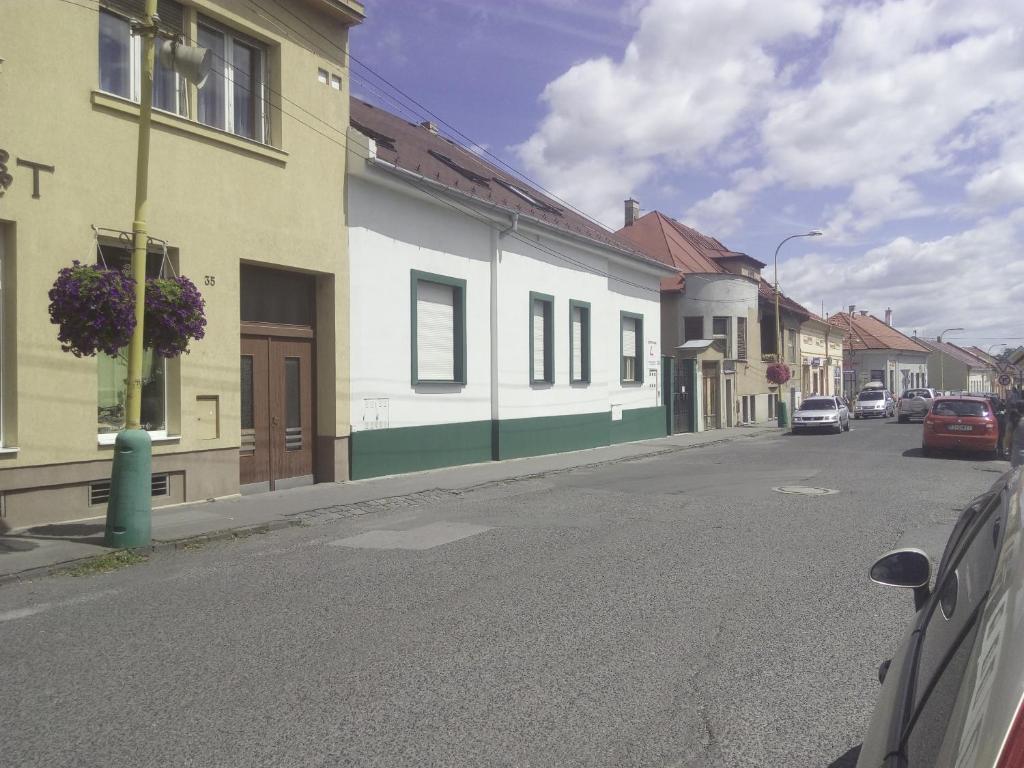 an empty street in a town with buildings at Apartments Bea in Lučenec