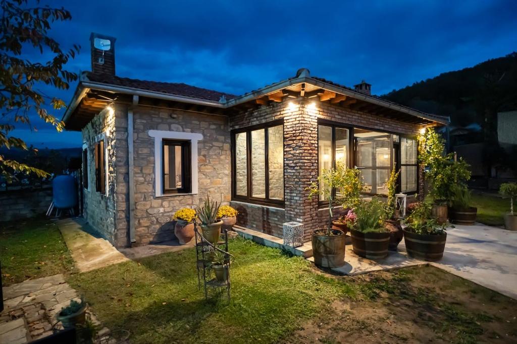 a small brick house with lights on it at Elia Guesthouse Chaidemeni in Tríkala