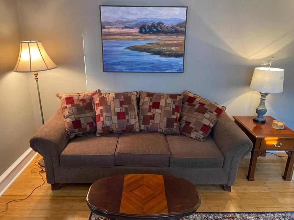 a living room with a couch and a table at Bryn Mawr Spacious Grnd Floor Apt Free Parking in Bryn Mawr