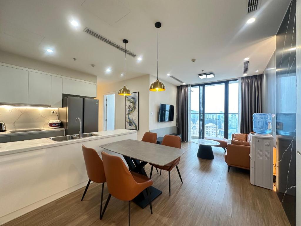 a kitchen and dining room with a table and chairs at Vinhomes Skylake Phạm Hùng Hà Nội Dani Apartment in Hanoi