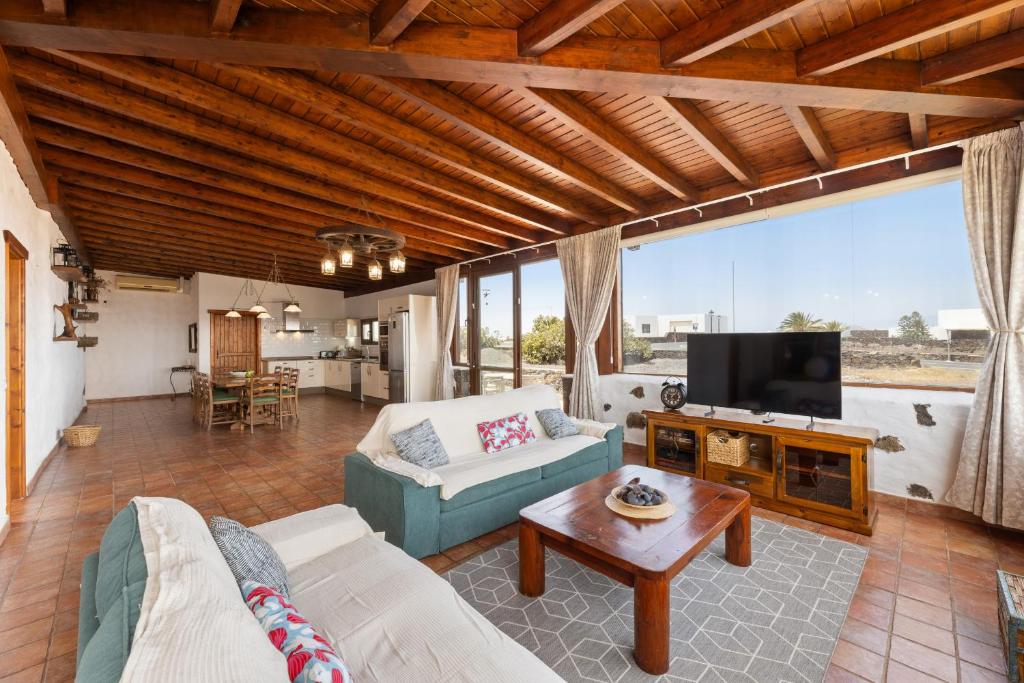 a living room with a couch and a tv at Finca Morro Herreno in Las Breñas