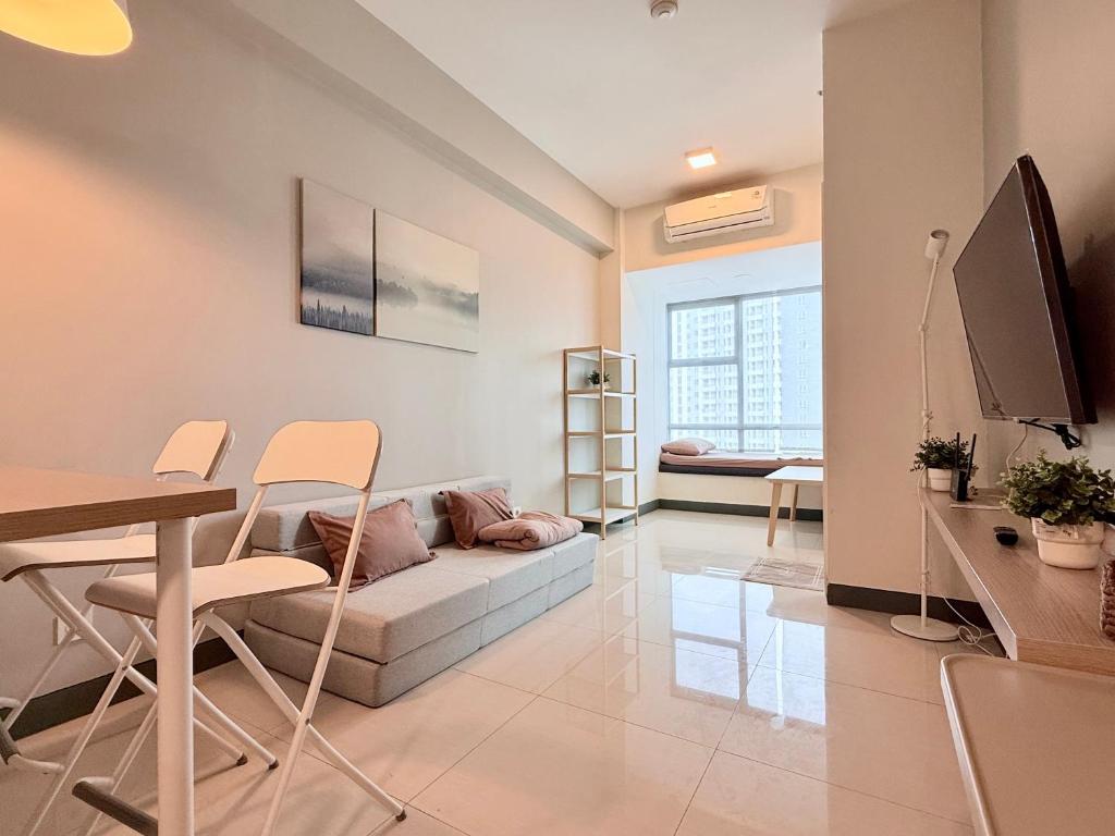 a living room with a couch and a table at Anderson pakuwon 2 Bedroom 6 people stay in Surabaya