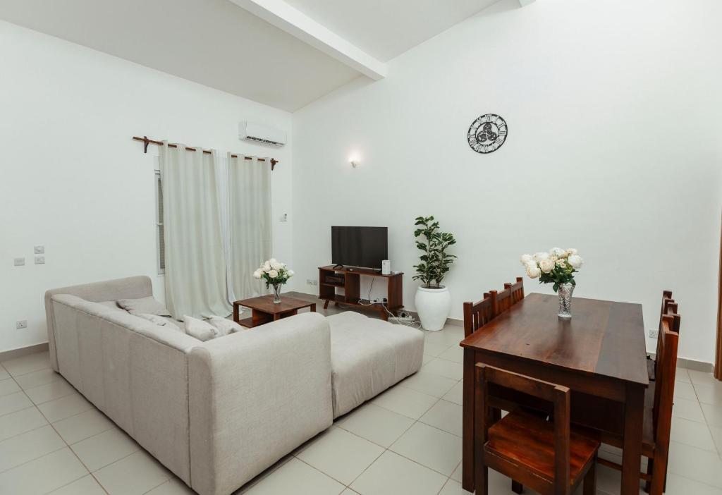 a living room with a couch and a table at Smile Homes in Zanzibar City