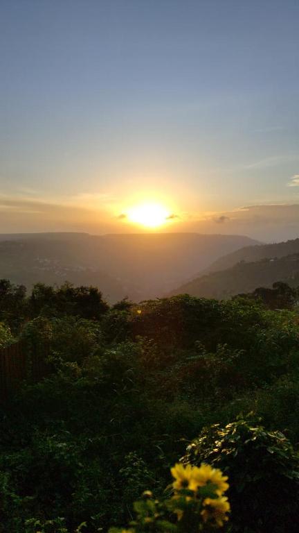 a view of the sun setting over the mountains at Shah Villa in Panchgani