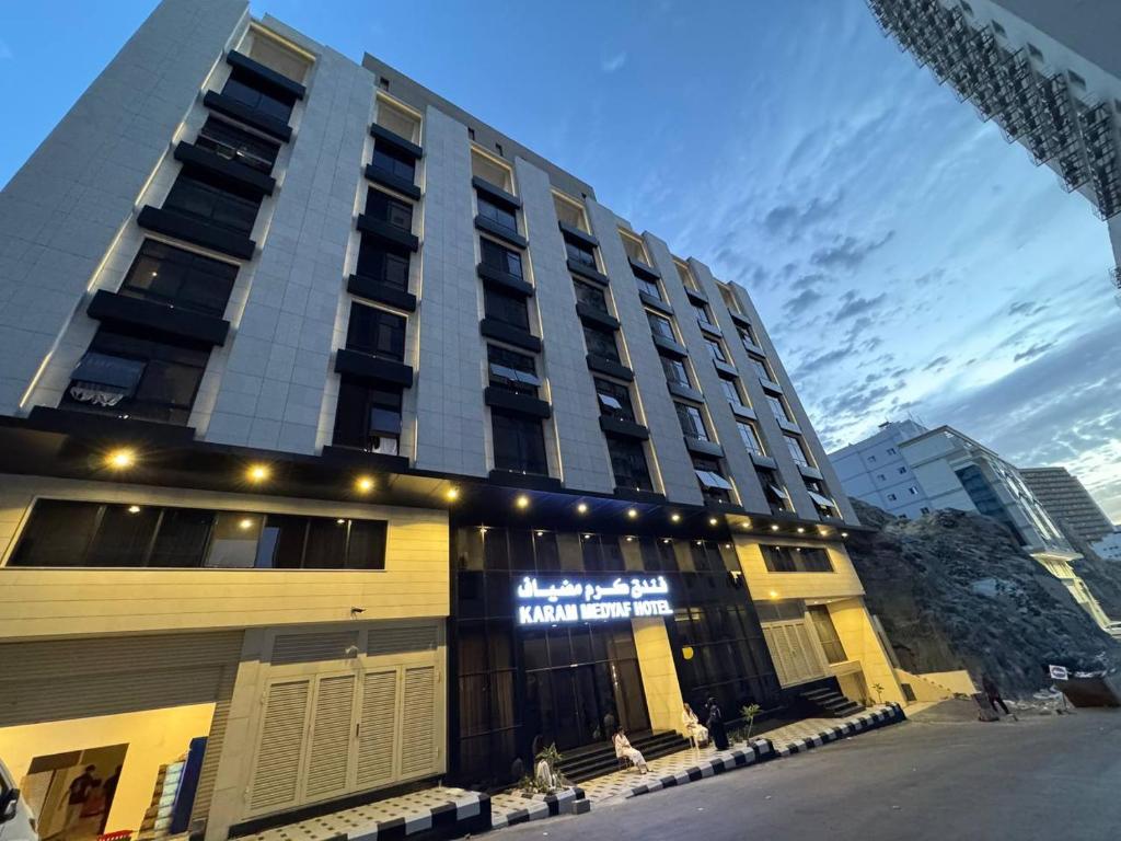 a building with a sign on the front of it at فندق كرم مضياف Karam Medyaf Hotel in Al Khansāk