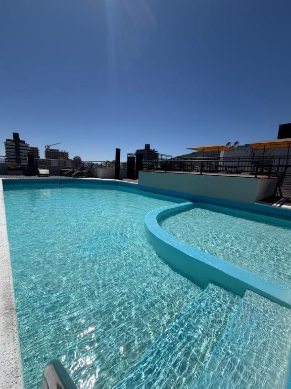 a swimming pool on the roof of a building at Depto Céntrico, Cochera, Pile, Terraza in Villa Carlos Paz
