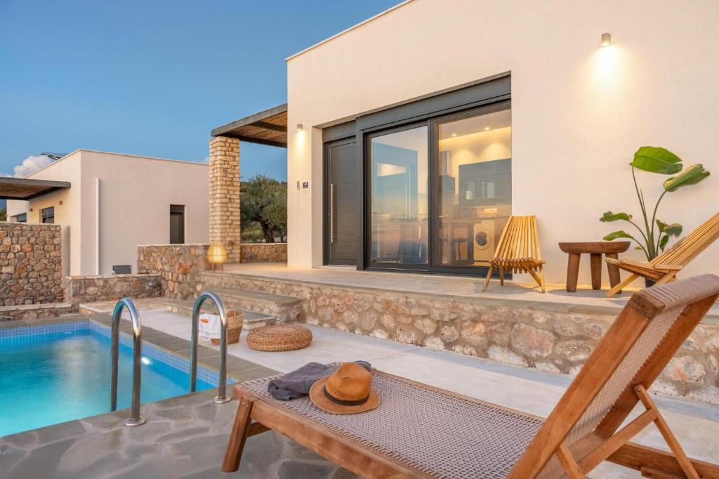 a villa with a swimming pool and a patio at Casatino Villas in Kalianeika